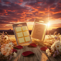 Golden Hour wax melt clamshell packages displayed on a weathered wooden fence rail against a vivid Western sunset sky with magenta, burnt orange, fiery red, and lavender clouds over desert mesas