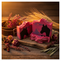 Long Live Cowgirls goat milk soap bars with horse silhouettes styled on rustic wood with dried wildflowers, leather, sage, and golden wheat in warm sunset light